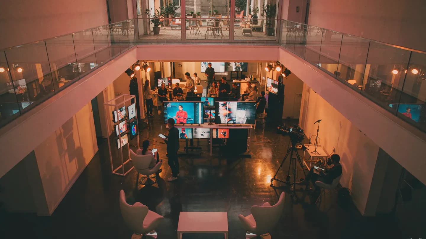 Enterprise video production studio with screens showing AI-generated brand footage
