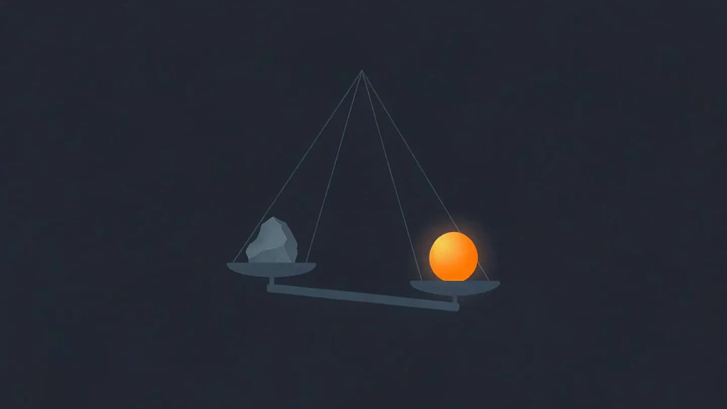 A balance scale on a dark navy field with a warm glowing ember outweighing a cold grey shard