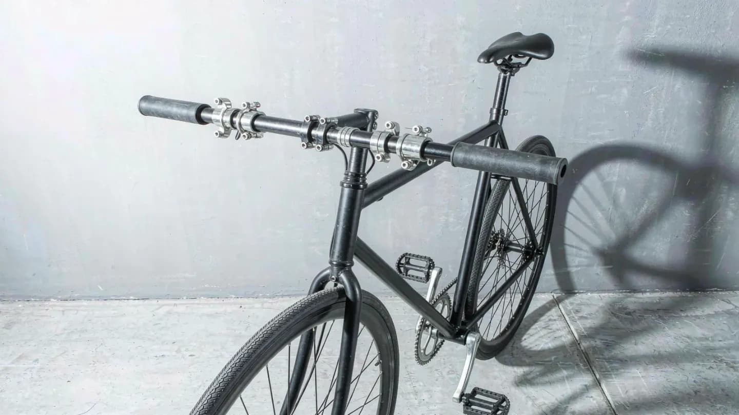 A photoreal bicycle frame showing a duplicated handlebar artifact