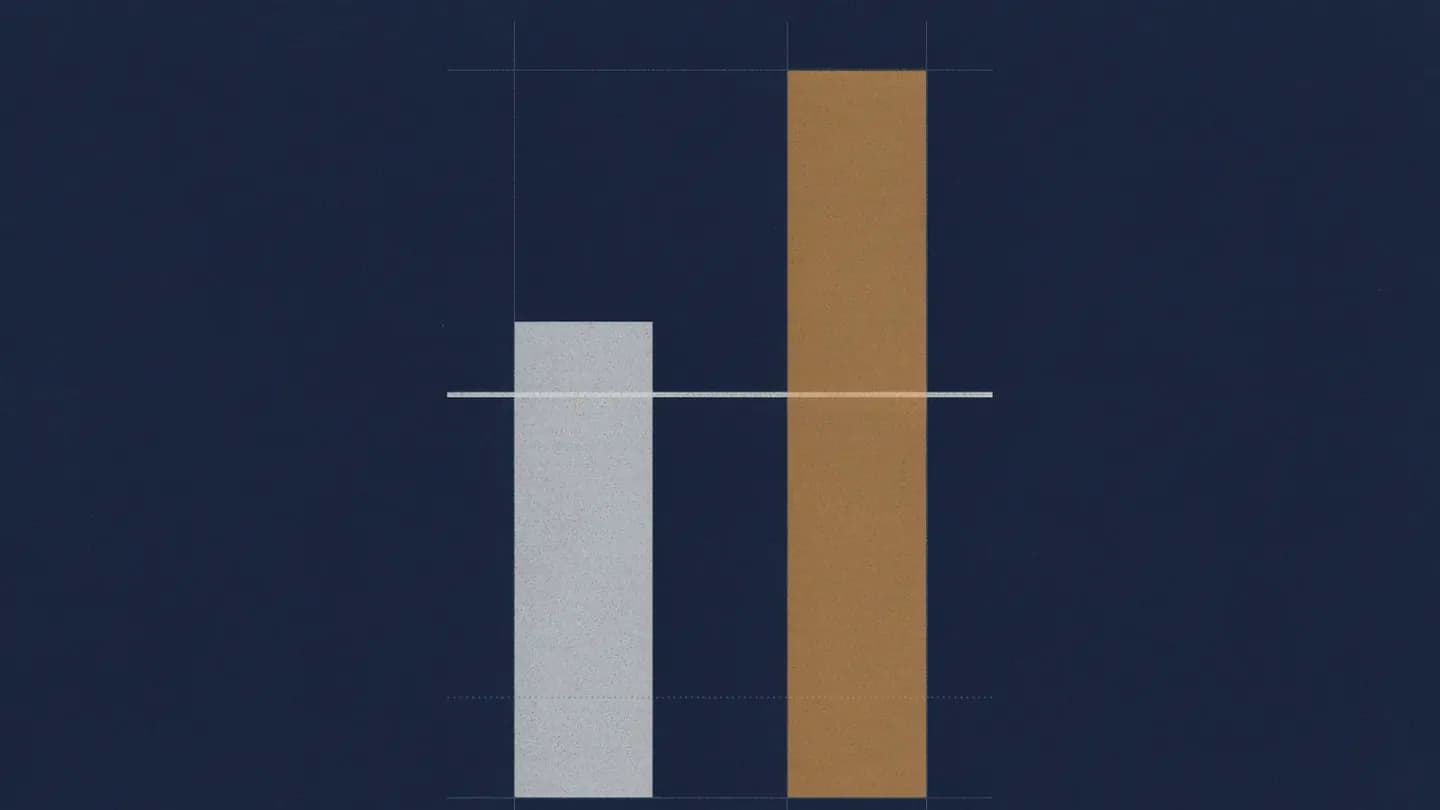 Two abstract inventory columns on a navy background where the amber column reaches a dotted threshold line above the grey one